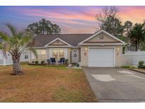 Charming home with a well-maintained lawn, a one-car garage, and a welcoming front porch at 105 Sebring Ln., Myrtle Beach, SC 29588