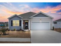 Charming single-story home with a two-car garage, tidy landscaping, and inviting curb appeal during a vibrant sunset at 1061 Sennema Circle, Myrtle Beach, SC 29588