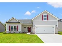 Charming one-story home with a two-car garage, a well-manicured lawn, and brick accents at 119 Old Chimney Ln, Conway, SC 29526