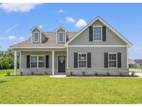 Charming single-Gathering home featuring a covered porch, dormer windows, and well-maintained landscaping at 127 Old Chimney Ln, Conway, SC 29526