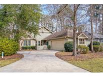 Charming home with lush landscaping, a two-car garage, and a lovely courtyard at 1827 Spinnaker Dr., North Myrtle Beach, SC 29582