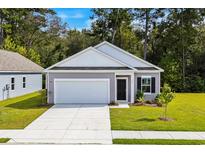 Charming one-story home featuring a gray exterior, a two-car garage, and a neatly manicured lawn at 235 Linares St., Loris, SC 29569