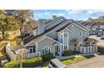 Charming condo with well-maintained landscaping and a cozy outdoor seating area; ample parking available at 435 Ocean Creek Dr. # 2705, Myrtle Beach, SC 29572