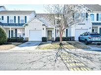 Charming townhome featuring a well-maintained lawn, attached garage, and a welcoming front entrance at 6095 Catalina Dr. # 1614, North Myrtle Beach, SC 29582