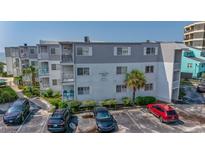 Oceanfront condominium complex with well-maintained landscaping and ample parking spaces on a sunny day at 6302 N Ocean Blvd. # C2, North Myrtle Beach, SC 29582