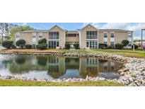 A picturesque view of the condo complex reflecting beautifully on the tranquil waters at 8735 Chandler Dr. # F, Surfside Beach, SC 29575