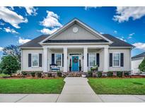 Charming single-story home featuring a welcoming front porch, blue front door, and manicured lawn at 1006 James Island Ave., North Myrtle Beach, SC 29582