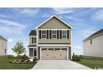 Charming two-story home featuring a two-car garage, traditional siding, and a well-maintained front yard at 1008 Oak Meadow Dr., Conway, SC 29526