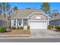 Charming one-story home featuring a well-manicured lawn, neutral siding, and an attached two-car garage at 1186 Pyxie Moss Dr., Little River, SC 29566