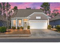 Charming single Gathering home featuring a two-car garage and a well-manicured lawn at 1186 Pyxie Moss Dr., Little River, SC 29566