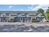 Charming townhouse exterior with blue siding, a gray roof, and a small front porch area with seating at 210 28Th Ave. S # 5, Myrtle Beach, SC 29577