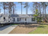 Charming single-story home features a welcoming porch, landscaped front yard, and a convenient driveway at 211 Hearthstone Ct., Myrtle Beach, SC 29588