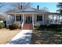 Charming two-story home featuring a classic wrap-around porch with columns and a well-manicured front yard at 213 S Farr Ave., Andrews, SC 29510