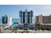 Stunning high-rise resort building with ocean views and blue and white accents on a clear, sunny day at 2201 S Ocean Blvd. # 1707, Myrtle Beach, SC 29577
