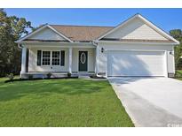 Charming single-story home with a well-maintained lawn, a covered porch, and an attached garage at 2315 Withers St., Georgetown, SC 29440