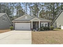 Charming single-story home with stone accents, a two-car garage, and well-maintained landscaping at 236 Craigflower Ct., Longs, SC 29568