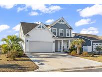 Charming two-story home with a two-car garage and a beautifully landscaped front yard, plus tropical palm trees at 2572 Brescia St., Myrtle Beach, SC 29579