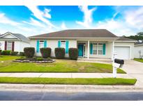 Charming single-story home featuring a well-manicured lawn and colorful blue shutters at 264 La Patos Dr., Myrtle Beach, SC 29588