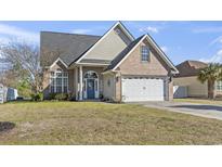 Charming home featuring a brick and vinyl exterior, well-manicured lawn, and inviting front entrance with a welcoming wreath at 2668 Corn Pile Rd., Myrtle Beach, SC 29588