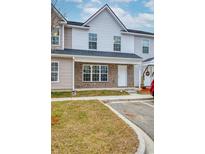 Charming townhouse featuring neutral siding, brick accents, and a well-maintained lawn at 2709 Mercer Dr. # 2709, Conway, SC 29526