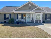 Charming single-story home featuring a welcoming front porch and well-maintained landscaping at 279 Beulah Circle, Conway, SC 29527