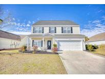 Charming two-story home featuring black shutters, a two-car garage, and a well-manicured front yard at 330 Brookmont Dr., Myrtle Beach, SC 29588