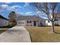 Charming one-story home featuring an attached garage and a well-maintained front lawn at 404 Wallingford Circle, Myrtle Beach, SC 29588