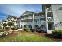 Charming condominium complex with well-maintained landscaping and multiple balconies at 4430 Eastport Blvd. # L9, Little River, SC 29566