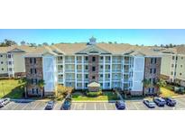 Beautiful condo building with stone accents and well maintained landscaping in a community with ample parking at 4865 Luster Leaf Circle # 402, Myrtle Beach, SC 29577