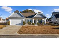 Charming single-story home with a well-maintained lawn, attached garage, and decorative shutters at 509 Hillsborough Dr., Conway, SC 29526