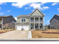 Charming two-story home with a welcoming porch and well-maintained lawn and a basketball hoop over the garage at 546 Calhoun Falls Dr., Myrtle Beach, SC 29577