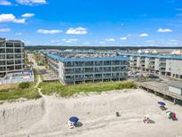Stunning view of a beachside condominium complex under a beautiful blue sky at 6000 North Ocean Blvd. # 204, North Myrtle Beach, SC 29582