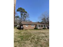 Charming brick home featuring a covered porch and a well-maintained yard at 704 13Th Ave. S, Myrtle Beach, SC 29577