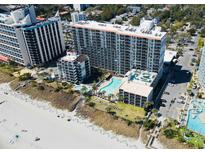 Stunning aerial view of the beachfront resort featuring pools, palm trees, and pristine sandy beach at 7200 Ocean Blvd. N # 1059, Myrtle Beach, SC 29572