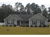 Charming single-story home with a landscaped front yard, showcasing its inviting curb appeal and well-maintained exterior at 95 Timber Run Dr., Georgetown, SC 29440