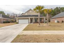 Charming single-story home with a well-manicured lawn and mature palm trees in a desirable neighborhood at 962 Henry James Dr., Myrtle Beach, SC 29579