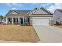 Charming single-story home featuring a two-car garage, covered porch, and beautifully landscaped front yard at 252 Lakota Loop, Longs, SC 29568