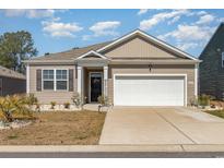 Charming single-story home featuring a two-car garage, well-kept landscaping, and a welcoming entrance at 255 Marauder Dr., Longs, SC 29568