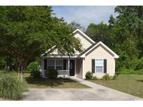 Charming single-story home featuring a well-maintained lawn, inviting front porch, and traditional siding at 456 Waccamaw Pines Dr., Myrtle Beach, SC 29579