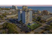 Stunning aerial view of a high-rise condo with beach and city views, parking and a tennis court at 601 Mitchell Dr. # 203, Myrtle Beach, SC 29577