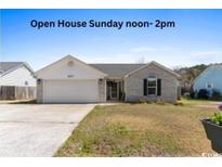 Charming single-story home with brick accents, well-maintained lawn, and attached garage, perfect for Gathering living at 620 Charter Dr., Longs, SC 29568