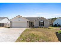 Charming single-story home with a well-manicured lawn and attached two-car garage at 620 Charter Dr., Longs, SC 29568