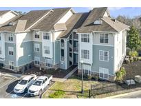 This building features lovely gray-blue siding, white trim, and well maintained landscaping and parking spaces at 70 Addison Cottage Way # 121 & 32, Murrells Inlet, SC 29576
