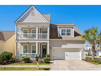 Charming two-story home with a double porch and a well-manicured lawn under a clear, sunny sky at 800 Lorenzo Dr., North Myrtle Beach, SC 29582