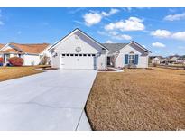 Charming home with a manicured lawn and two-car garage on a sunny day at 920 Don Donald Ct., Myrtle Beach, SC 29588