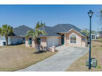 Charming single-story home featuring a well-manicured lawn and a private driveway at 9827 Simonton Ct., Murrells Inlet, SC 29576