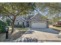 Charming single-story home with a well-manicured lawn and a gray brick facade at 1019 Hillsdale Dr., Little River, SC 29566