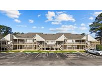 Spacious condo complex featuring multiple units, ample parking, and wooden staircases at 1095 Plantation Dr. W # 27M, Little River, SC 29566