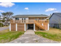 Coastal home with a spacious deck, elevated design, and ample parking space at 406 47Th Ave. S, North Myrtle Beach, SC 29582