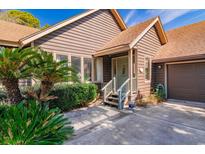 Charming front entrance featuring a cozy porch and well-maintained landscaping, creating an inviting curb appeal at 438 Aspen Loop, Pawleys Island, SC 29585